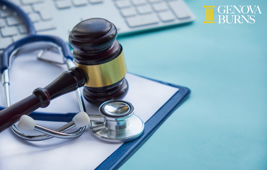 gavel and stethoscope medical jurisprudence and keyboard on blue background